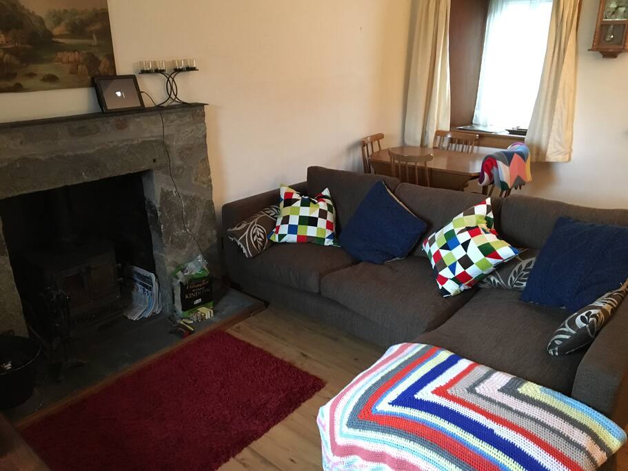 Living room is freshly decorated, has a big, comfy sofa, flat-screen TV, Blu-ray, Apple TV and soundbar