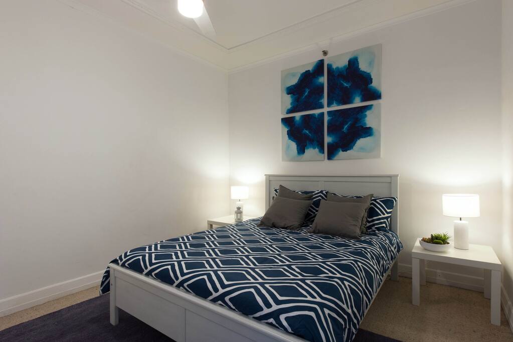 Comfy Queen bed in a neat and tidy room.