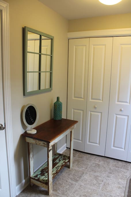 Bright entryway into the apartment furnished with local pieces.