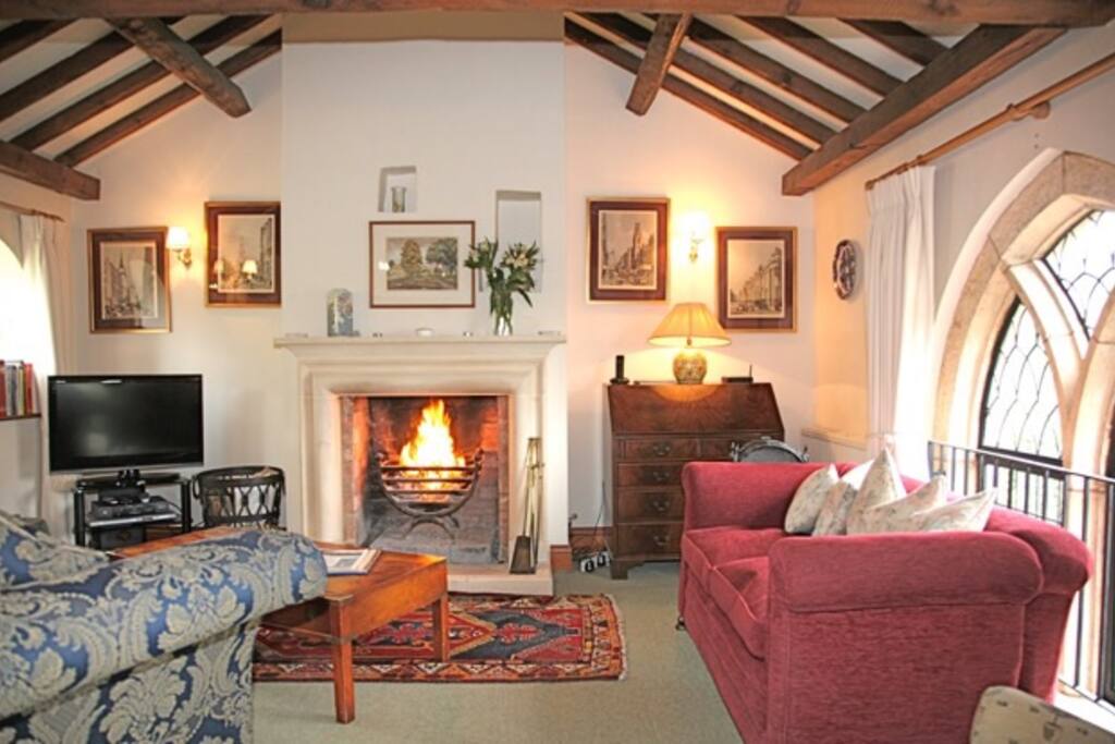 Vaulted and beamed upstairs living space with open fire