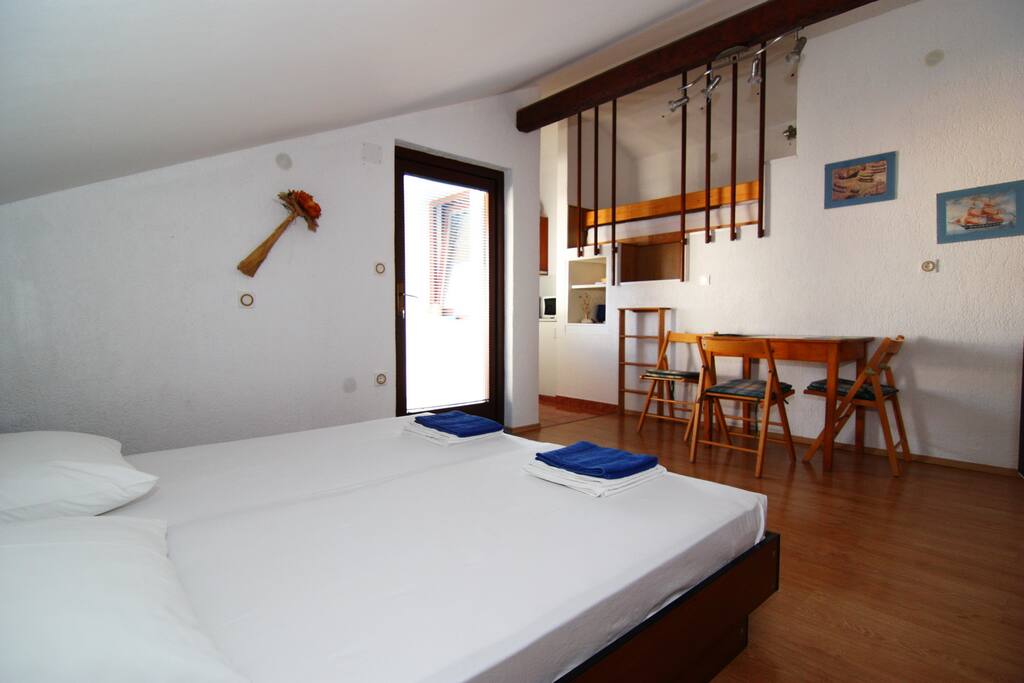 Near table are letter leading to spare bed