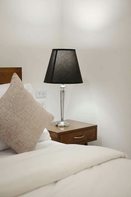 Comfortable beds, linens and nightstand because a good night's sleep is extremely important!
