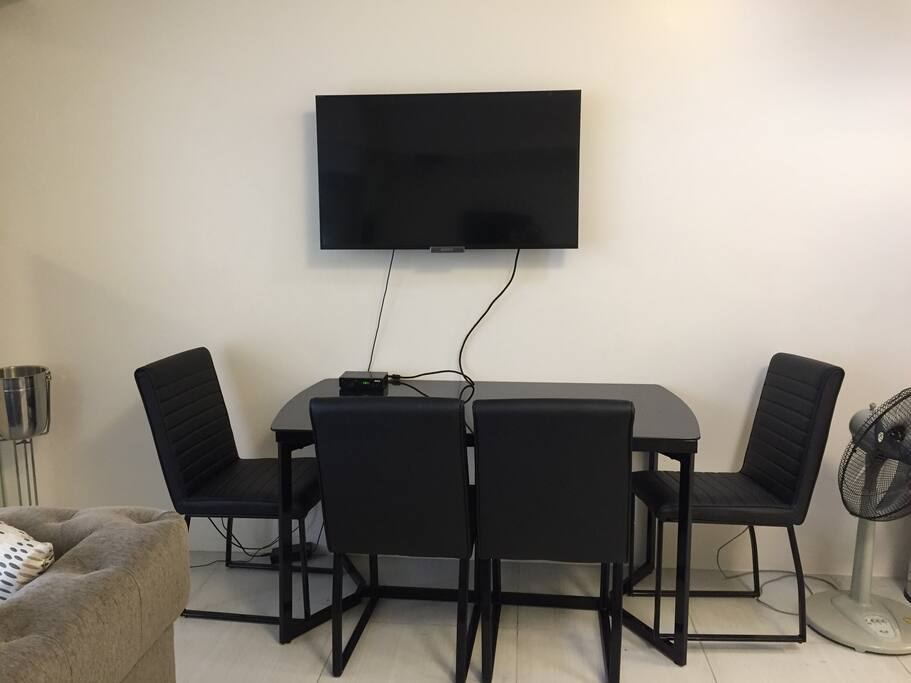 Dining table, flat screen tv with local shows and news and electric fan
