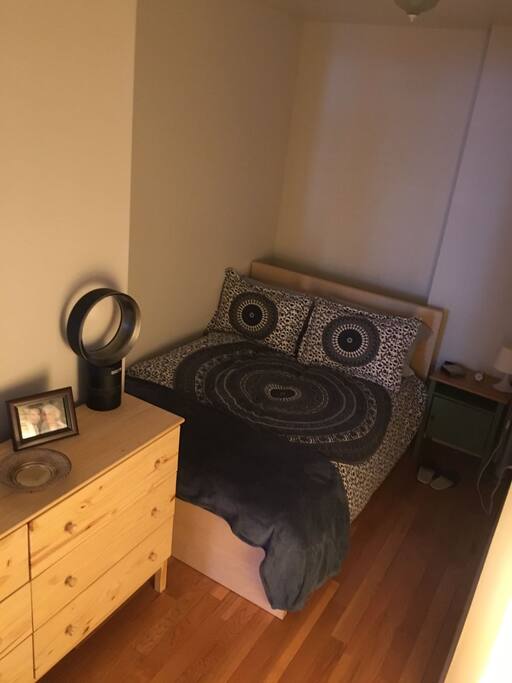 Bedroom with Queen Bed, Chest of Drawers, and Dyson Fan