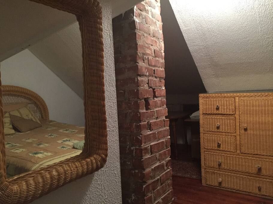 Exposed brick interior adds character and a rustic charm to the room. Dresser for storing your belongings.