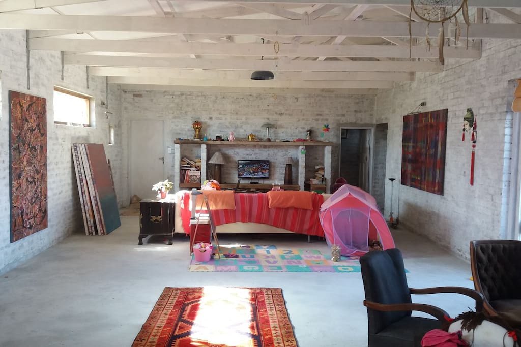 Enormous open plan living room with fireplace, and kitchen