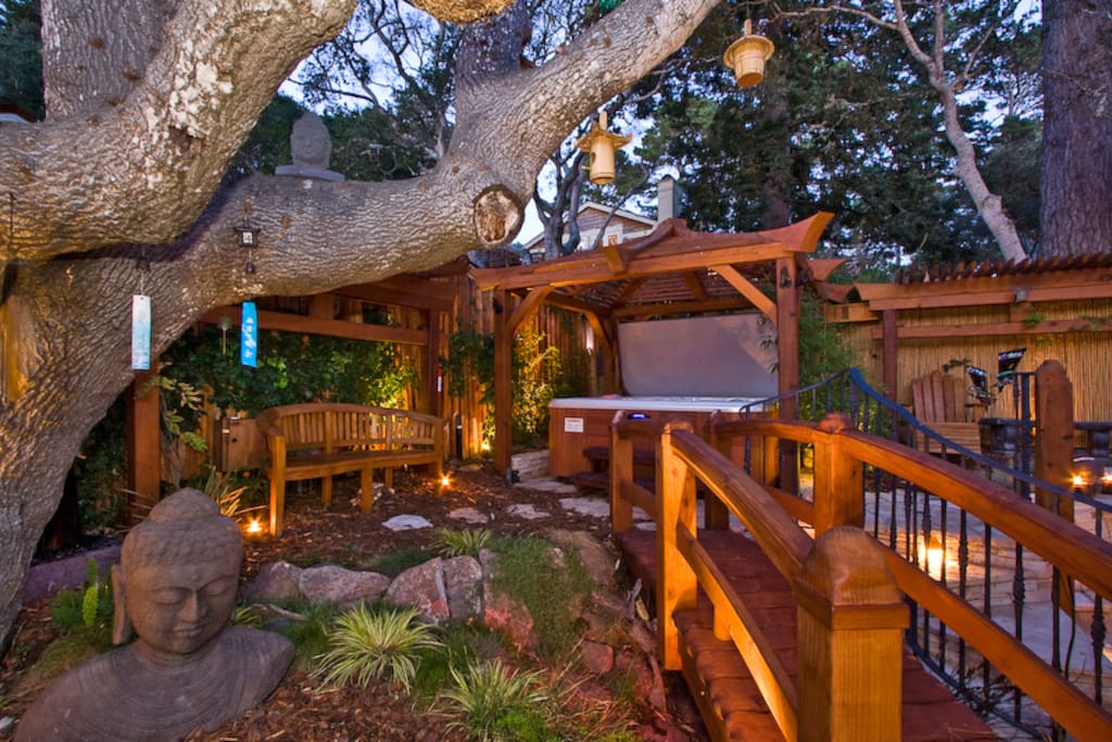 A stone Buddha rests beside the Tree of Truth. An arched bridge crosses over the butterfly pit.
