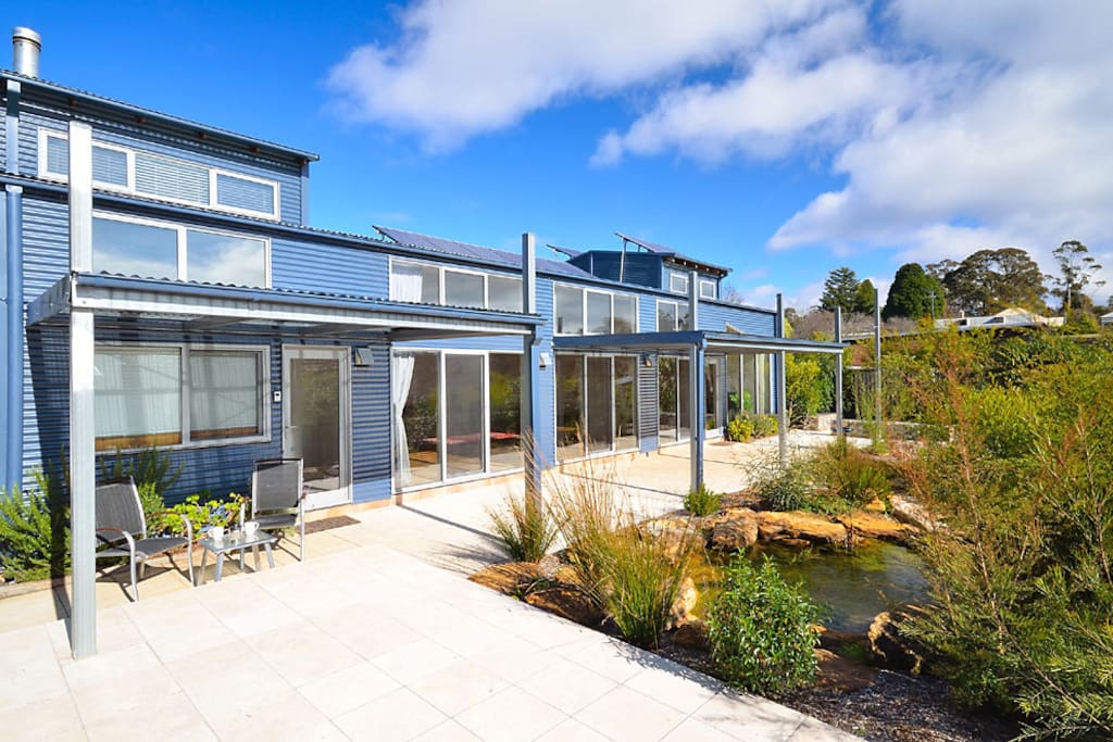 tranquil landscaped native bush garden and pond with natural waterfall feature