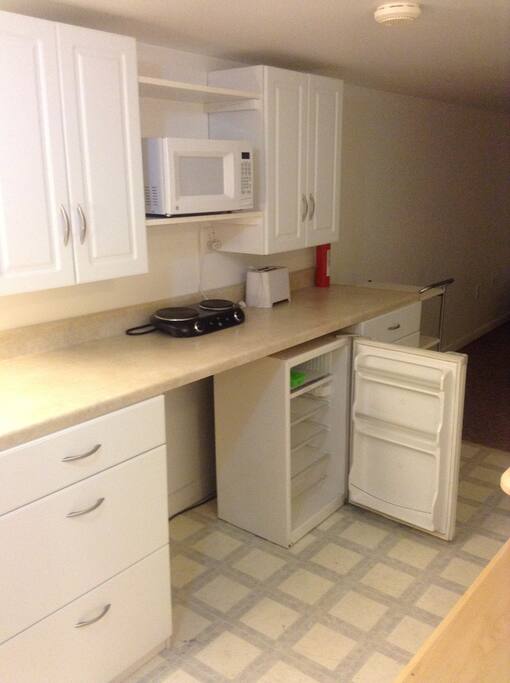Kitchenette with fridge, microwave, and a toaster oven in the near future.