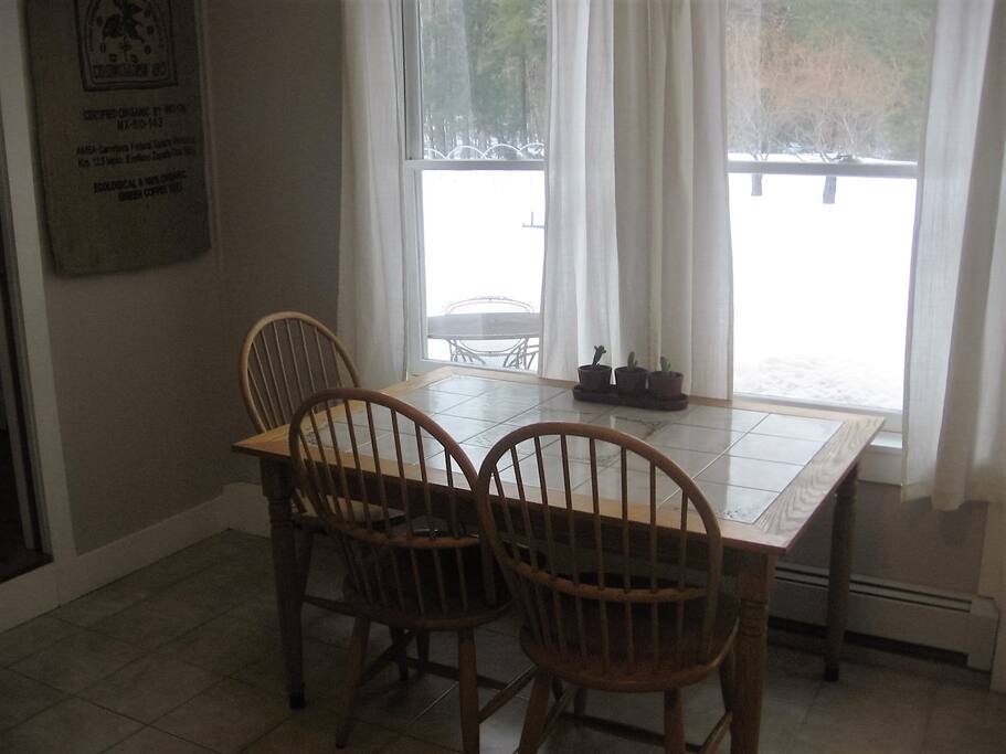 Kitchen table looks out on yard