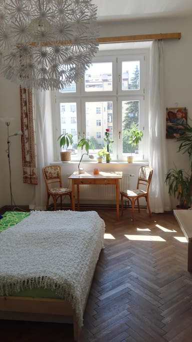 a quiet room facing to a big courtyard with trees planted in the 1920ies, when the house was built