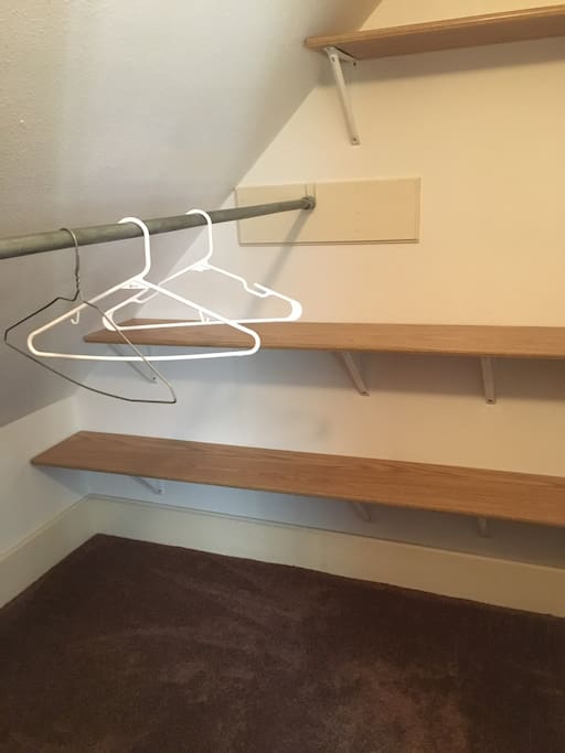 Walk-in closet for hanging clothes and organizing luggage/souvenirs.