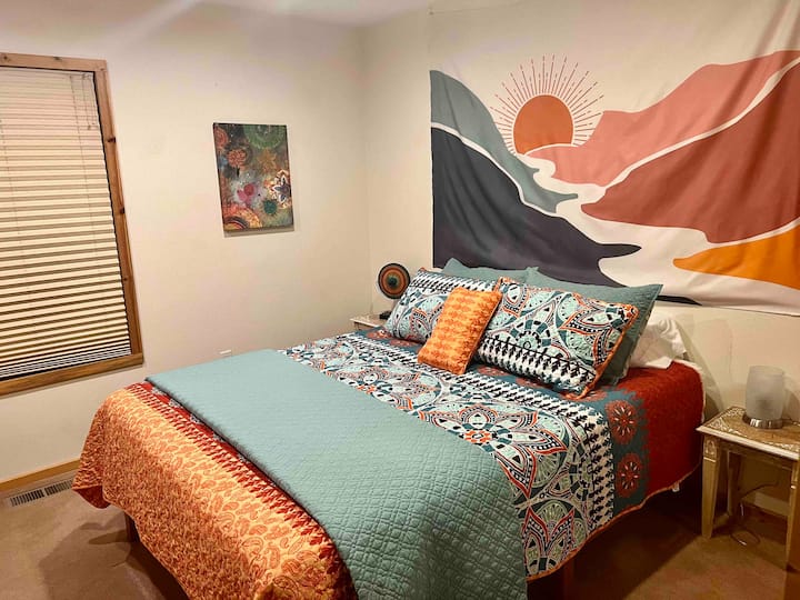 سرير بحجم كوين في غرفة النوم في الطابق الرئيسي على طراز بوهو. 