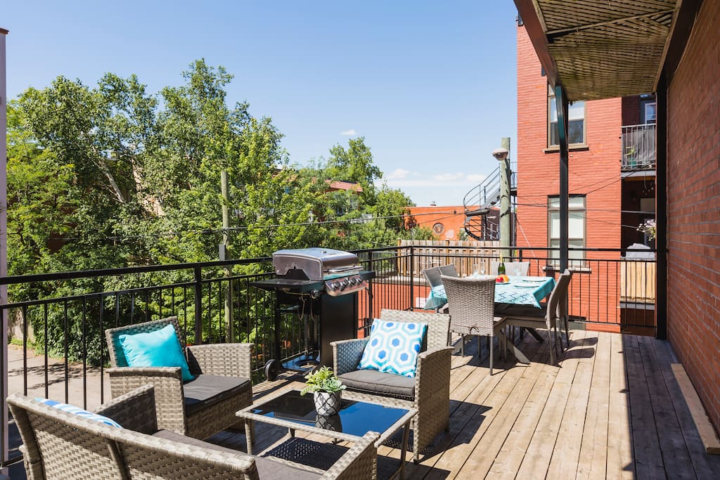 Sunny terrace with table, BBQ and outdoor furniture