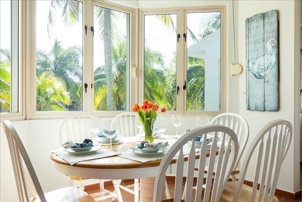 The dining room overlooks palm trees, fountains, a
