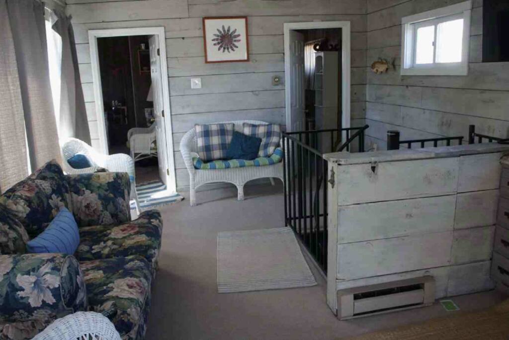 Spiral staircase to upstairs living room with Bedfoom 1 and bathroom w/shower/tub, 2nd kitchenette
