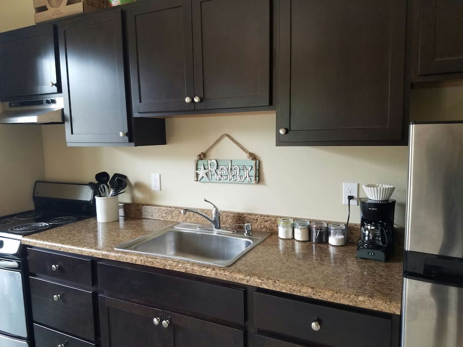 Stocked kitchen! Coffee, tea, dishes, pots and pans all ready for some home cookin'