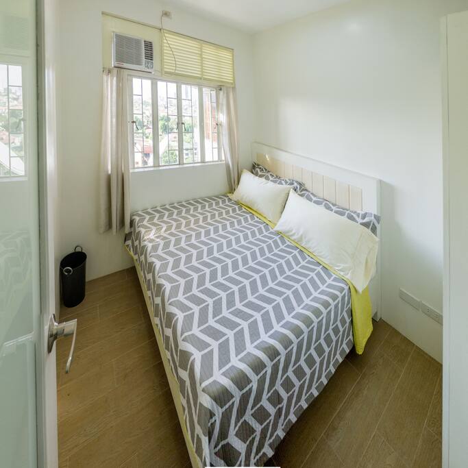 The 10Ideal Master Bedroom, where you'll be getting a good night's sleep on the queen-size bed after your tiring day of travelling. You'll have a fully functioning air conditioner and wardrobe at your disposal. Sheets are washed the day after every check-out, so the bed is fresh and clean upon your check-in. Sweet dreams!