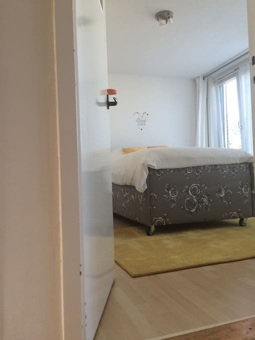 Birdy Bright is a beautiful and clean bedroom with bright light, natural furniture and happy yellow details.