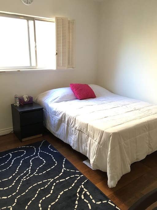 Queen size bed with nightstand.
