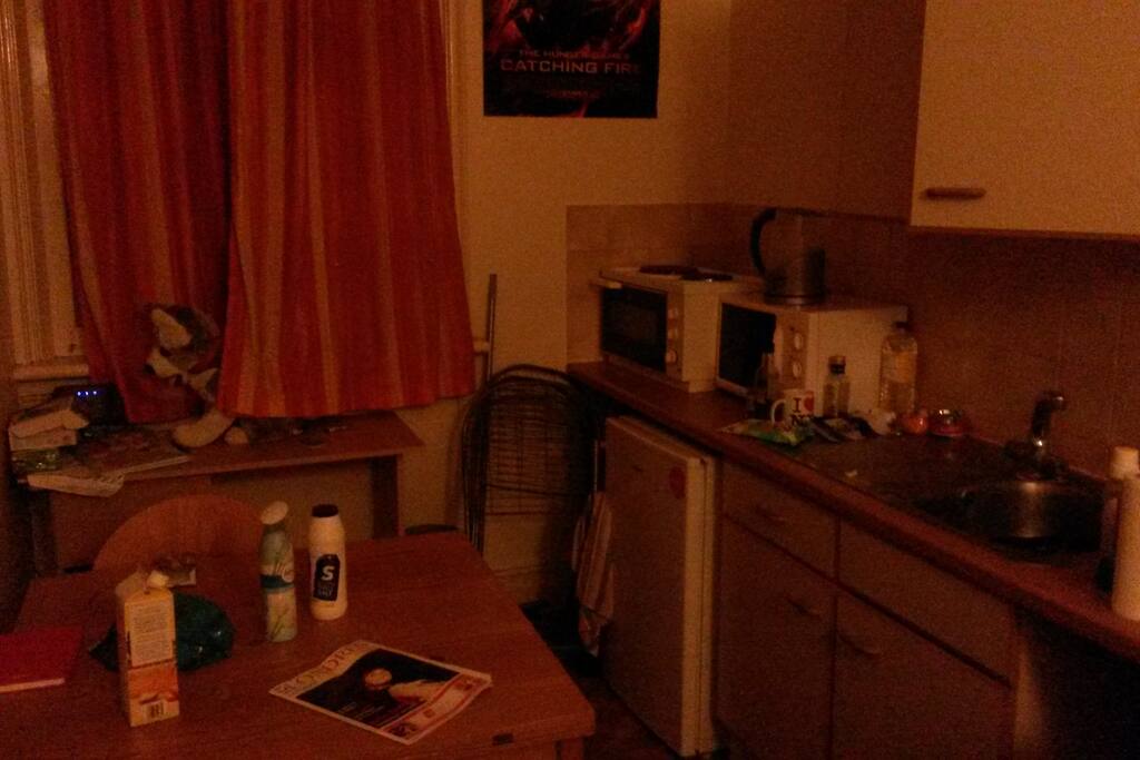 Kitchen are with microwave, table, all necessities