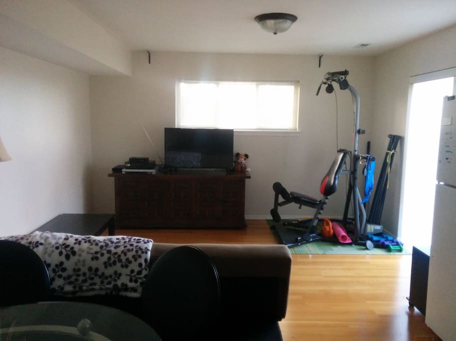 Private living room - Hardwood floors, 40" TV, Futon sofa, and Bowflex