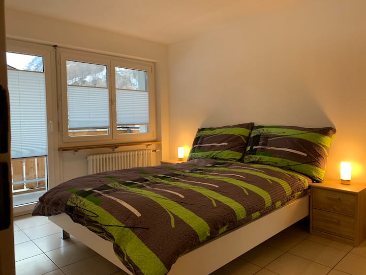 Bedroom with queen bed and balcony