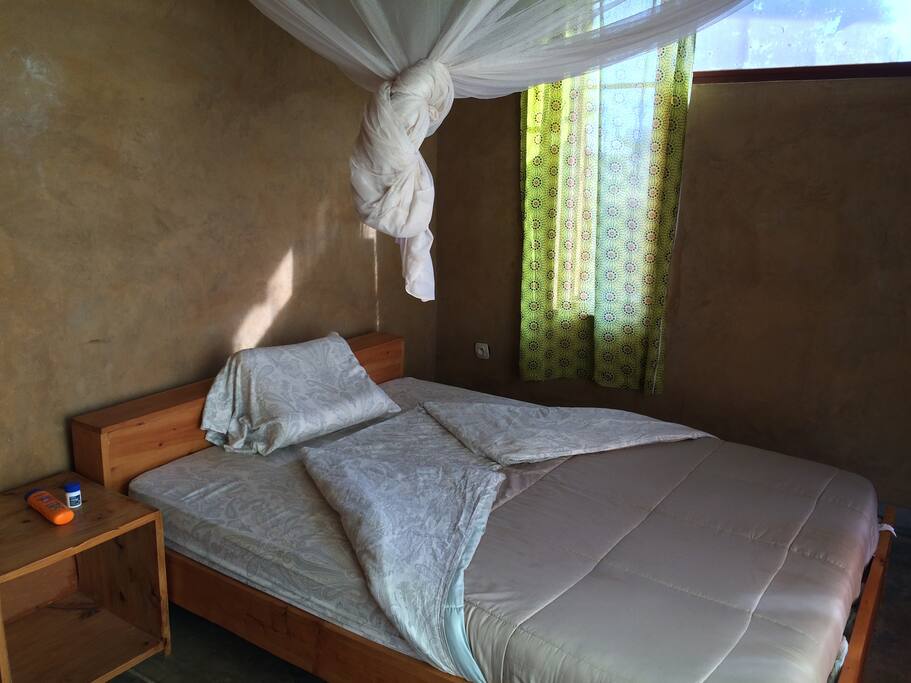 Bedroom 3 - All rooms have queen-sized beds with linens and mosquito nets with closet rods and shelves.