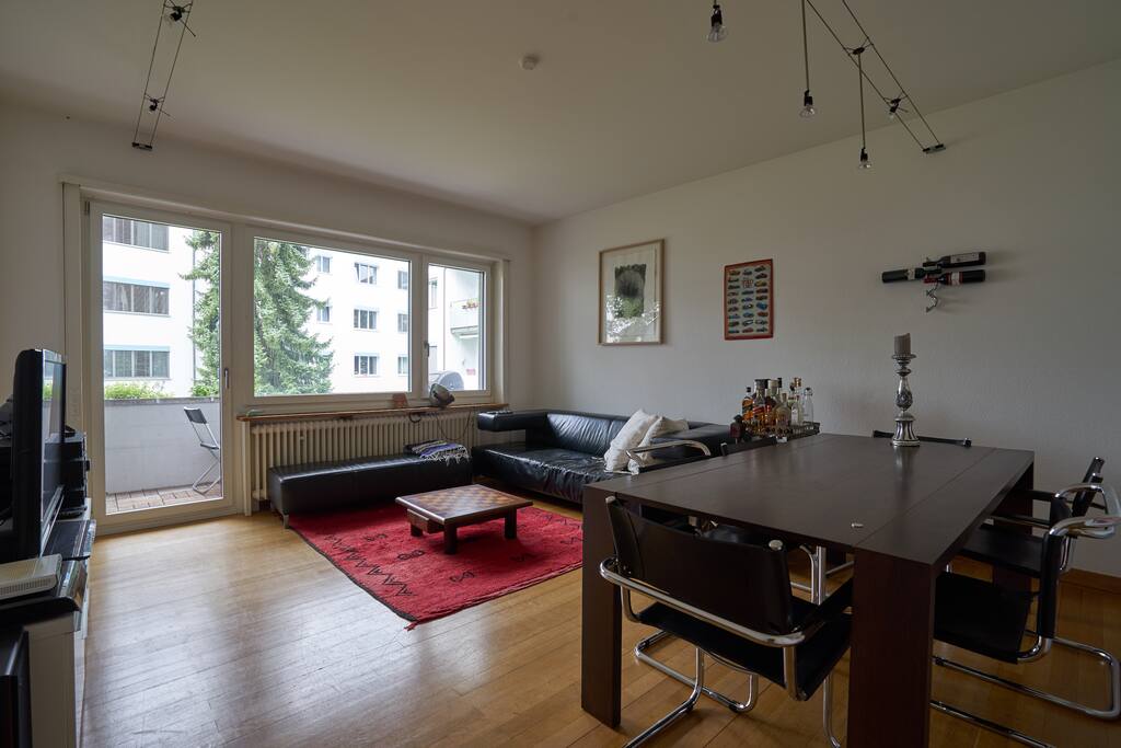 The living room with couch, table and TV