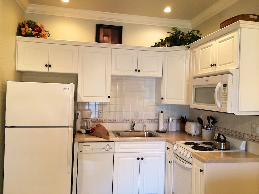 Kitchen has a stove, oven, microwave, dishwasher, microwave, fully furnished.