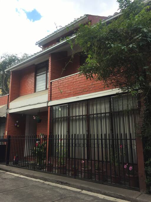 View of the house from the outside, there is also a small park in front of the house.