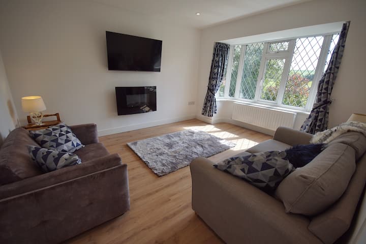 Second living room. Real effect electric  fire, 50" tv,  sofa bed, views across the valley.