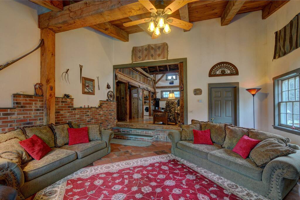 View from living room into the dining and kitchen area with loft above.