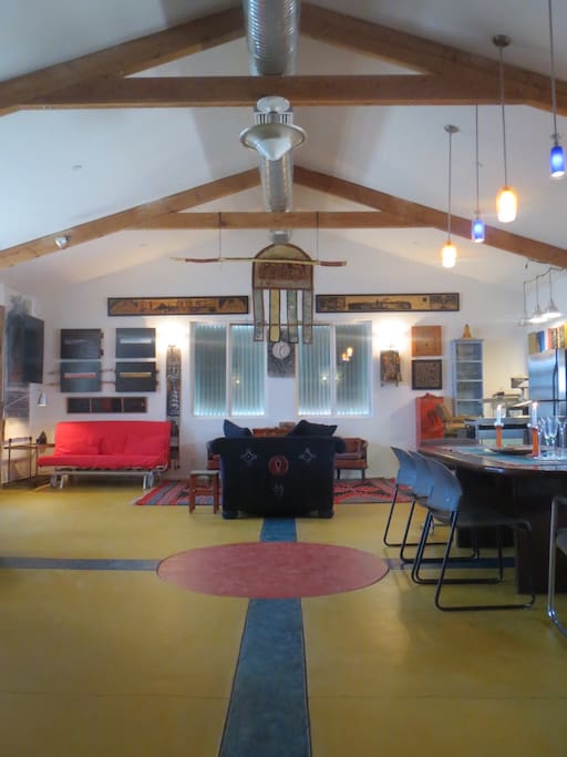 Large main room with open kitchen, additional guests sleeping and entertaining.