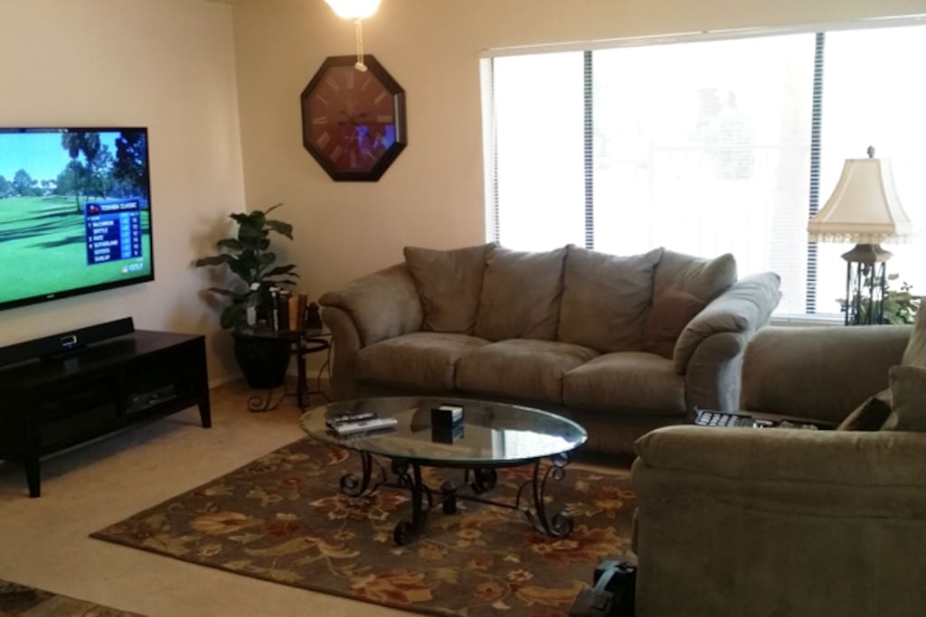 Warm and bright living and TV area with 65" flat screen, Blu Ray DVD player, Wi Game system, Google Chromecast and full surround sound bar!