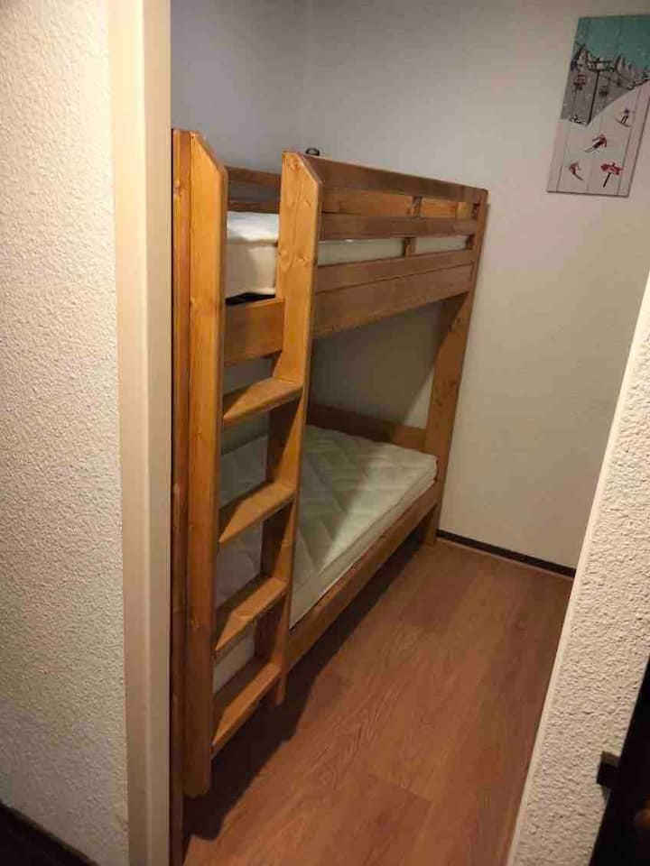 Cabin area with adult bunk beds and large storage closet 