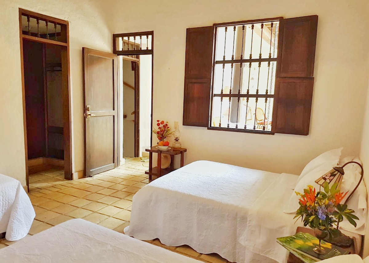 Alcoba # 3  with two double beds and a single,  with a window to the courtyard, with bathroom and dressing room.