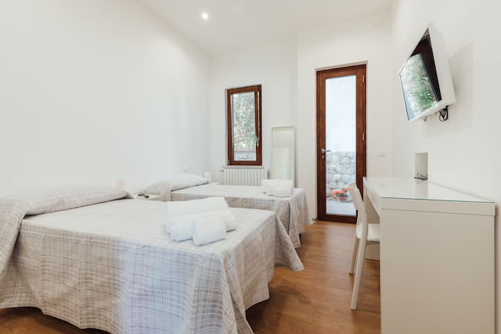 Bedroom with single beds, upon request double; direct access to outdoor space on the mountain side