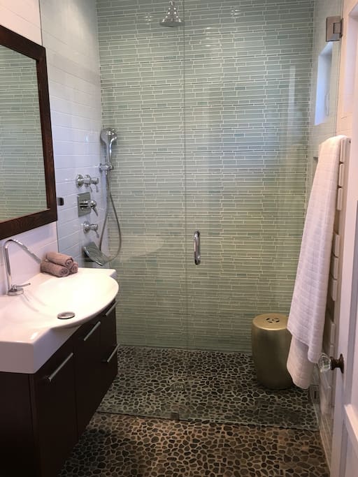 Spa-style bathroom-(tankless water heater, large shower stall with dual overhead and hand held shower heads).