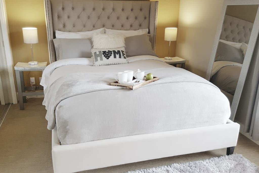 Bedroom is highend comfort from the gorgeous Muse & Merchant velvet upholstered bed, crisp and cool GlucksteinHome percale sheets, memoryfoam Beautyrest mattress, hypoallergenic featherbed topper, down pillows and duvet.