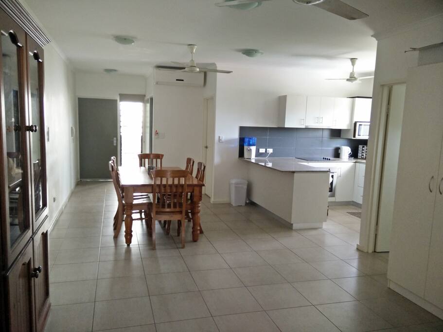 Dinning room and modern kitchen featuring several windows delivering lots of natural light
