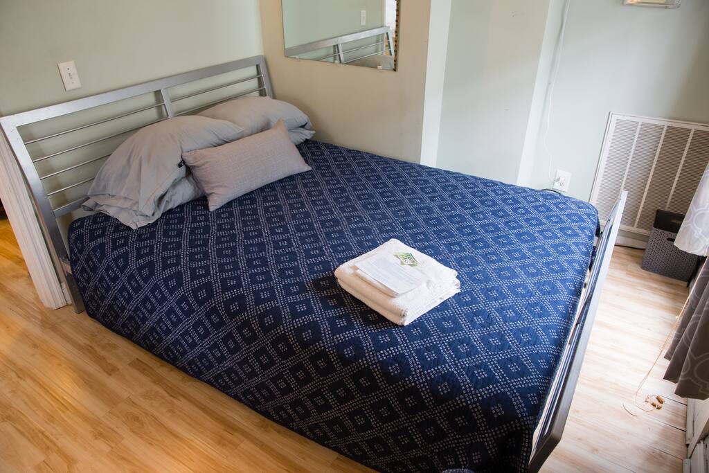 The Monet room, located downstairs with a queen bed and big windows.