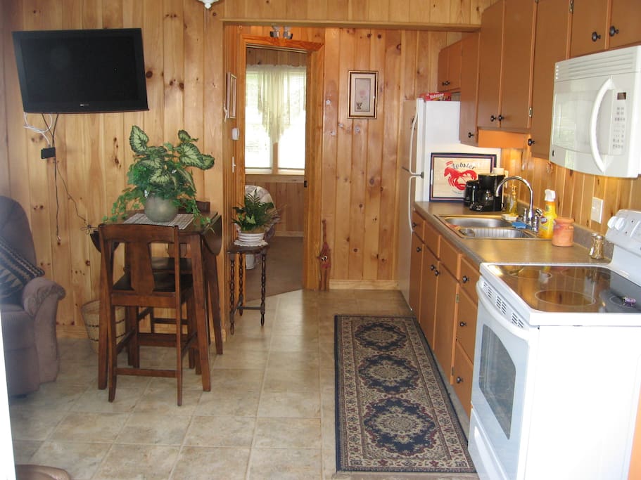 kitchen/dining area, full fridge, stove and microwave, toaster, coffeemaker, blender, crockpot