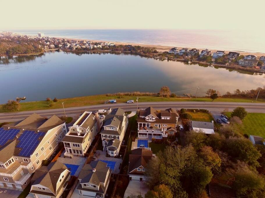 From the air, the house sits on the lake with the ocean behind. Minutes walk to the beach.