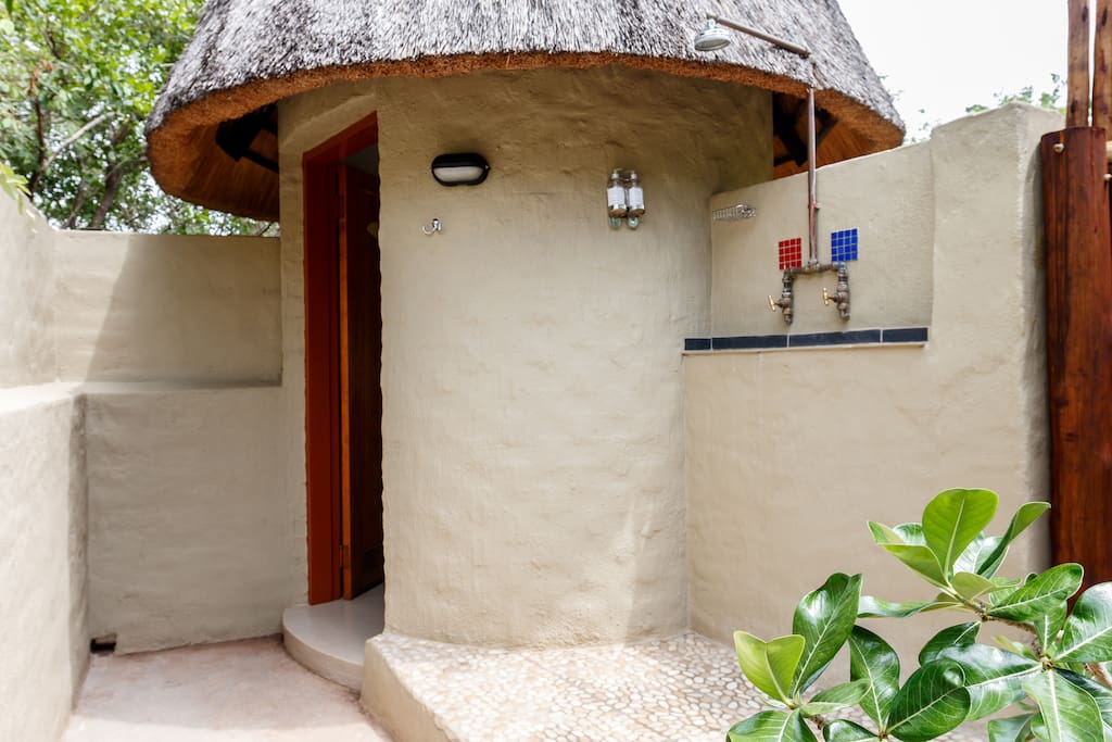 Outdoor Shower in Private courtyard. Toilet and basin in little rondavel.