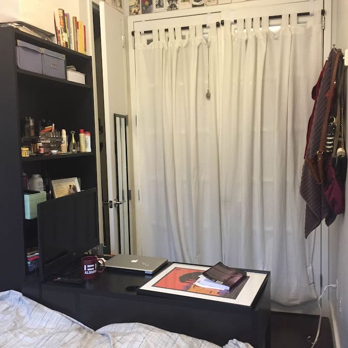 Bedroom has a closet, hooks and high ceilings