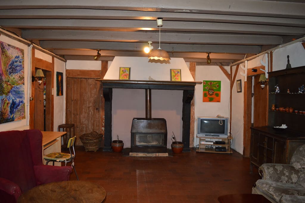 The living room looking east showing the fire place. The TV has recently been replaced by a newer model