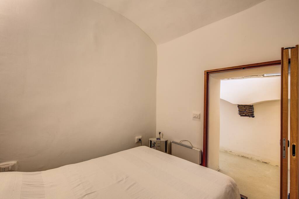 Bedroom with a double bed, dresser, heater and dehumidifier