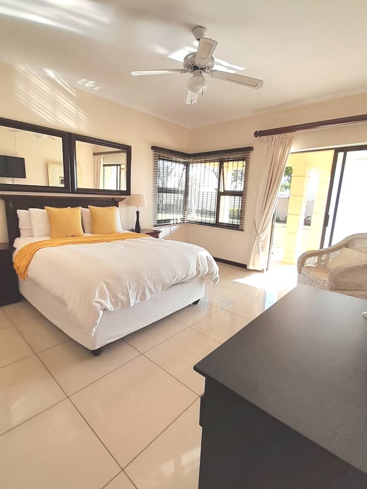 Bedroom 2, queen bed, shower ensuite,  ceiling fan, balcony, TV.