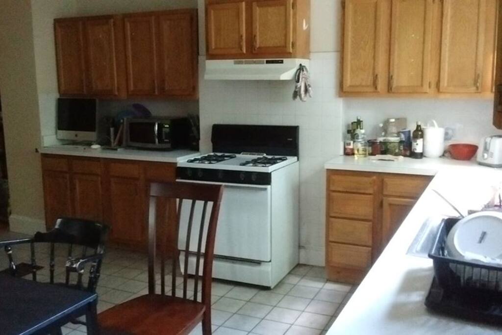 Our kitchen includes a dishwasher and tons of space for cooking and eating. It opens into the living room where the sofa is.